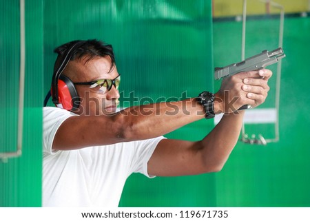 Man with gun at shooting range