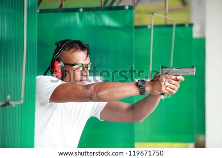 Man with gun at shooting range