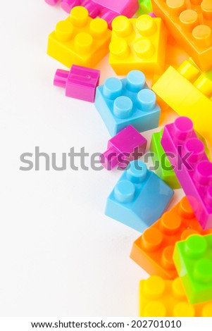 Toy building colorful blocks on white paper background