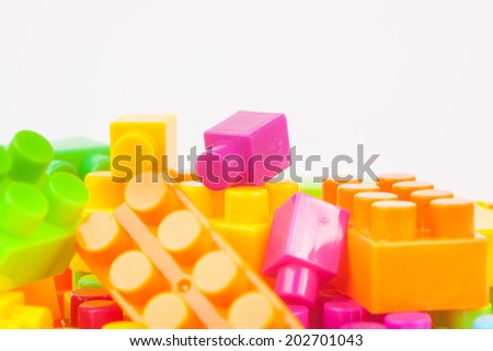 Toy building colorful blocks on white paper background