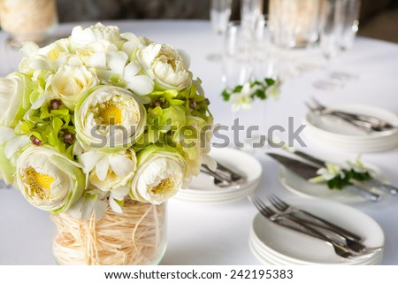 Floral arrangement at a wedding ceremony on the beach.