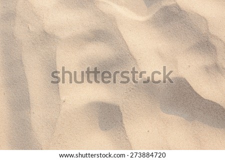 closeup of sand pattern of a beach in the summer/sand texture