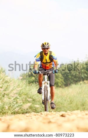 Person riding a bike downhill  to the river