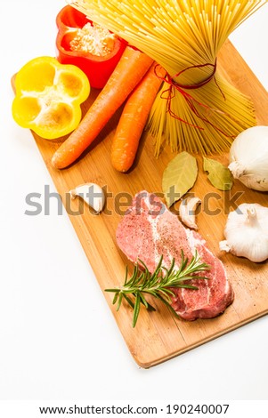 Food ingredients scattered around the cutting board. Isolated with light shadow.