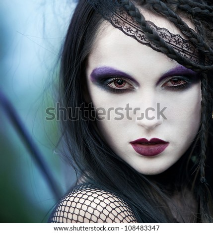 girl with black hair with dark make-up. image for the cover of book