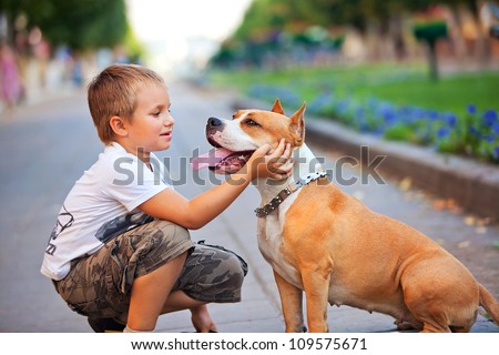 Happy Young Boy And His Dog In Summer Street