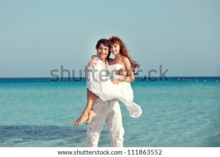 happy young newly married couple in love traveling at the sea on honeymoon