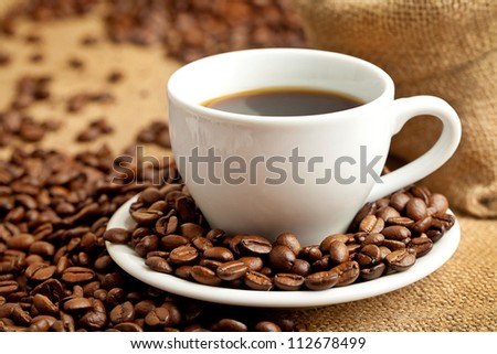 black roasted arabic coffee and cup with hot coffee
