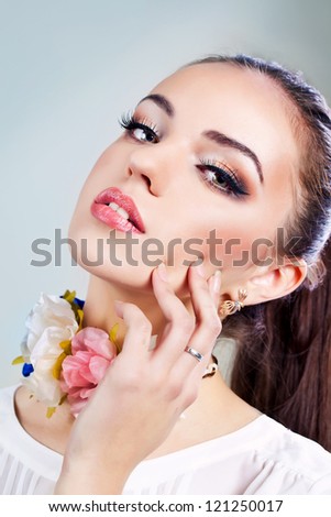 Portrait of a beautiful female model with flower necklace