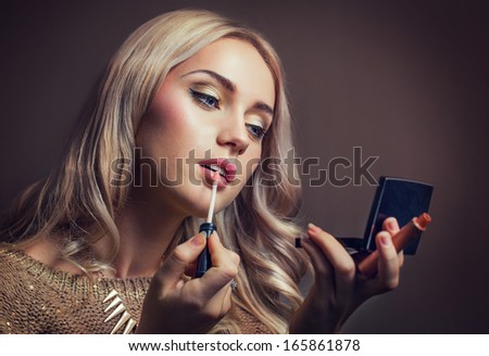 Portrait of a woman making up