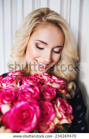 Beautiful woman with red roses bouquet. Valentine gift