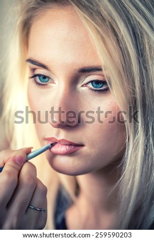 Woman with makeup brush. Stylist lipstick. brush. make up artist