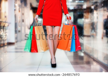 Beauty Woman With Shopping Bags In Shopping Mall. Sale Concept