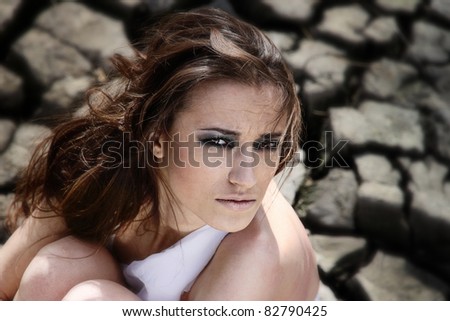 Female figure being in cracked earth