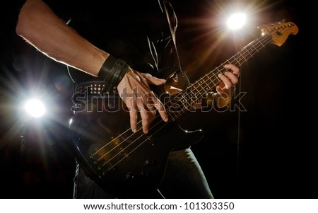 playing rock guitarist surrounded with lights