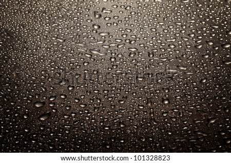 stylish background of black droplets on glossy background