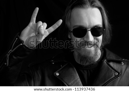 handsome rock man making a sign of horns