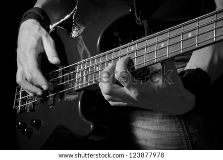 closeup of man playing the guitar, black and white