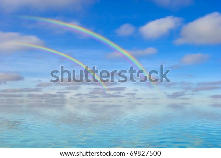 two rainbows on blue sky over endless water