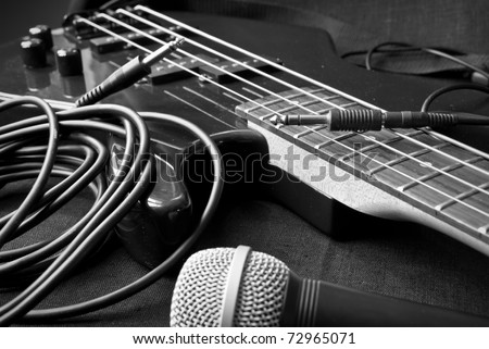 still life with electrical guitar, microphone, jacks; black and white