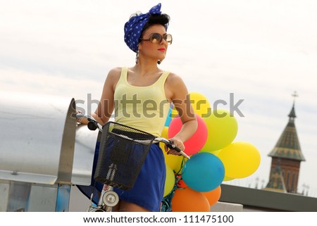 beautiful pin up with balloons on a bicycle