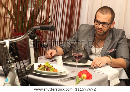 young man enjoying meal with a a bike
