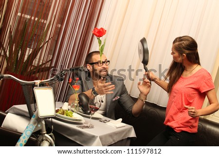 An attractive caucasian couple having a meal with wine at restaurant with a bike