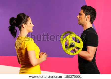 People in gym or fitness club exercising. Personal trainer