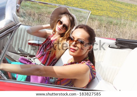Beautiful women driving a red car wearing accesoriess