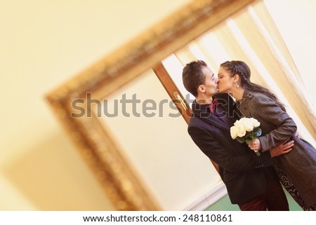 Couple kissing in the mirror