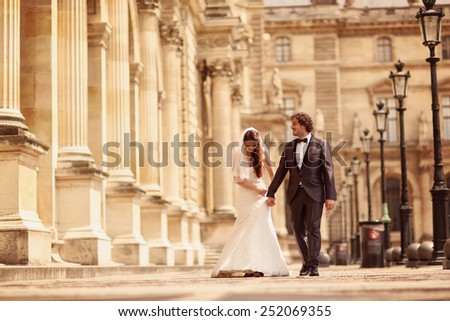 Bride and groom walking in Paris