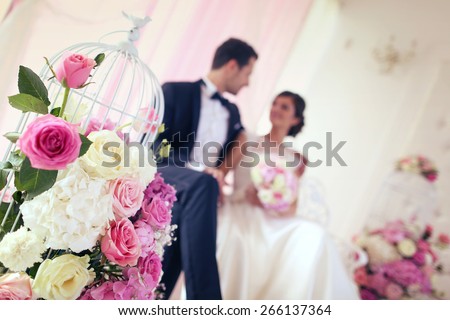 Bride and groom surrounded by flowers