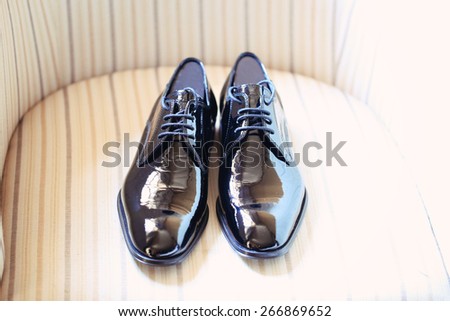 Men\'s shoes on striped chair