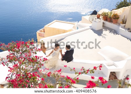groom and bride on the roof of a house in Santorini