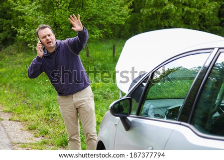 Driver got his car broken on the road and use phone to call service or any kind of aid