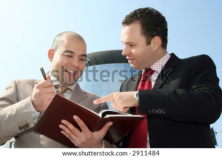Two businessmen in the middle of conversation about job