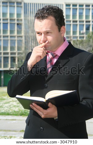 Business man in the middle of writing and thinking up the business building