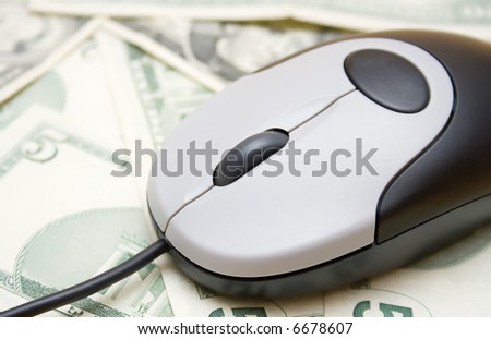 Money spend over internet, computer mouse on the dollar bills