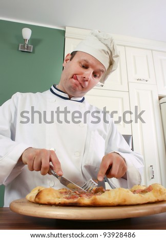 Chef is cutting pizza slice to try the taste of it