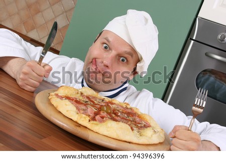 Crazy chef is prepared for eating pizza with fork and knife