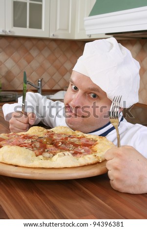 Crazy chef is prepared for eating pizza with fork and knife