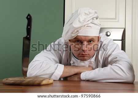 Chef with cap look at you with horror look and wait yours order
