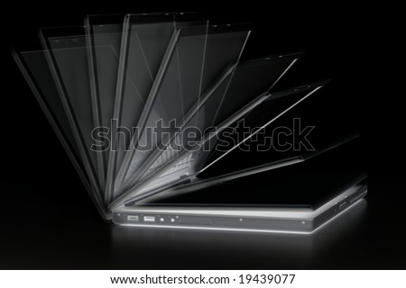 An image showing the various stages of an opening laptop, isolated on a black background.