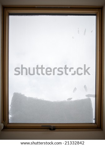 Image of a dormer-window powdered with snow.