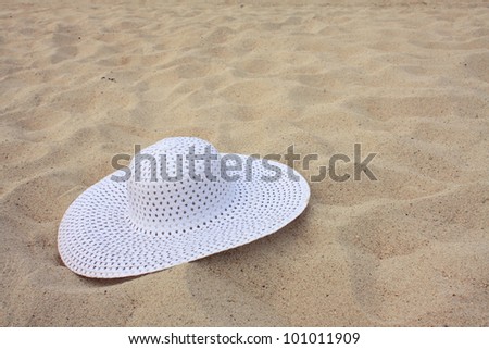 White hat on the beach sand