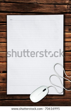 Computer Mouse on white paper on the old wood wall