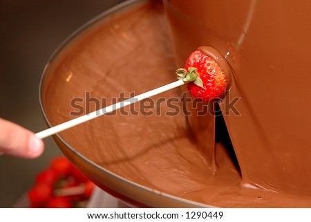 Dipping a Strawberry into a Chocolate Fountain