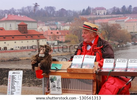 PRAGUE, CZECH REPUBLIC - NOVEMBER 18: An unidentified man offers music from hand operated music box in exchange for money. Taken on Charles Bridge in Prague, Czech Republic on November 18 2012