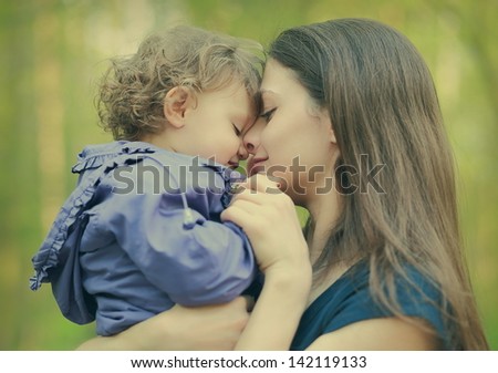 Happy Loving Mother And Baby Girl Embracing Outdoor Summer Background. Closeup Portrait