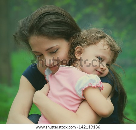 Happy Loving Mother And Girl Cuddling Outdoor Summer Background. Closeup Tender And Love Portrait